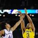 Michigan sophomore Trey Burke takes a three-point shot over Kansas senior Kevin Young to tie the game and send it to overtime in the second half at Cowboys Stadium in Arlington, Texas on March 29, 2013. Melanie Maxwell I AnnArbor.com